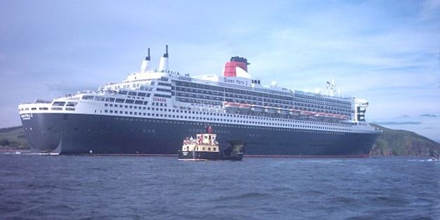 Ferry in front of the QM2