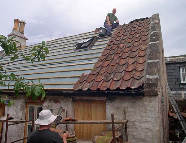 Pottery Workshop - pantiles going back on roof