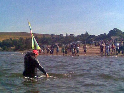 Dr Charley walking up the beach at Cromarty afer swimming across the firth