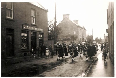 Pipe Band in High Street on a very wet day