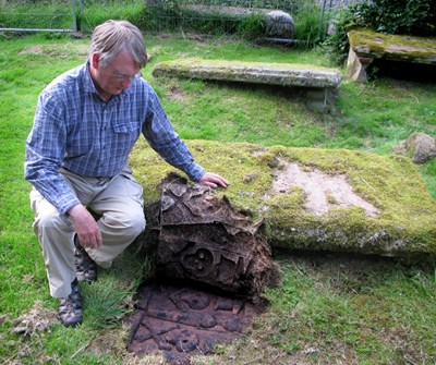 Revealing a gravestone at the East Church