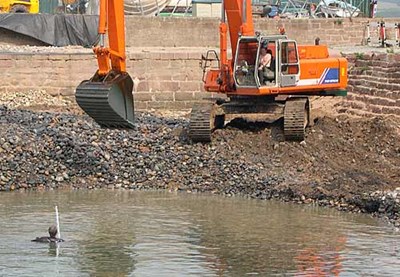 Harbour being dredged (with man in water)