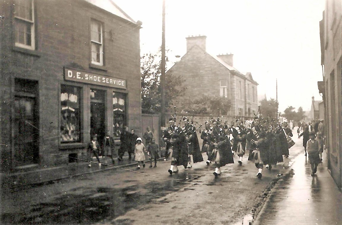 Pipe Band in High Street on a very wet day